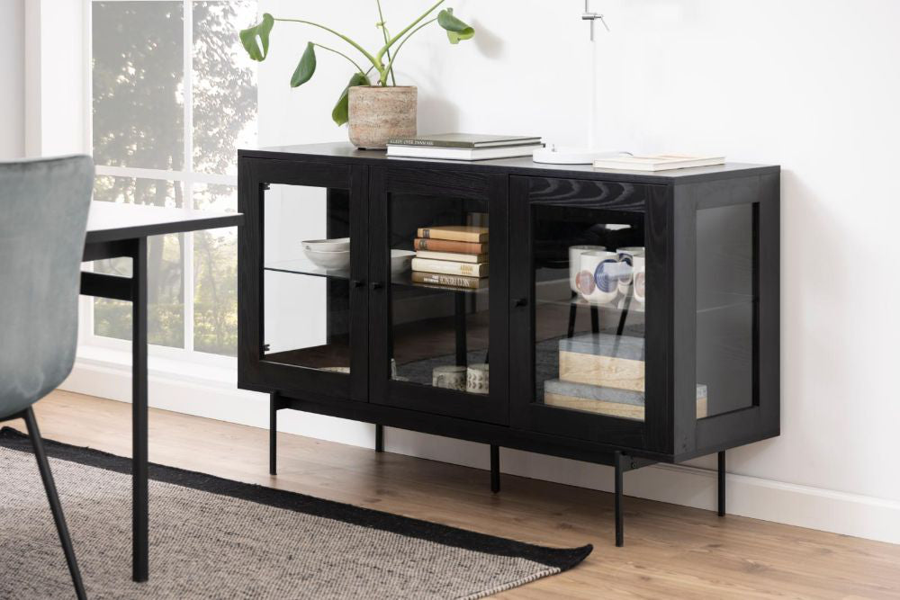 Angie 3 Door Sideboard in Black Finish with Indoor Plant and Books Inside in Dining Setting