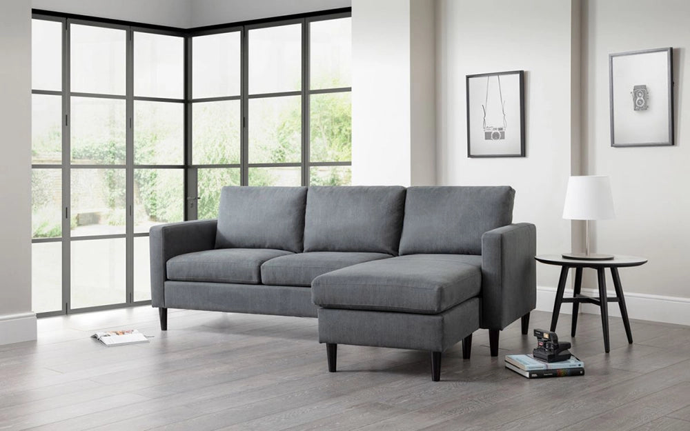 Aria Upholstered Corner Sofain Grey Finish with Four Wooden Leg Coffee Table and Wall Frame in Livng Room Setting
