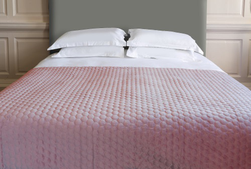 Bedspread Geometric Throw in Blush Finish with Pillows in Bedroom Setting