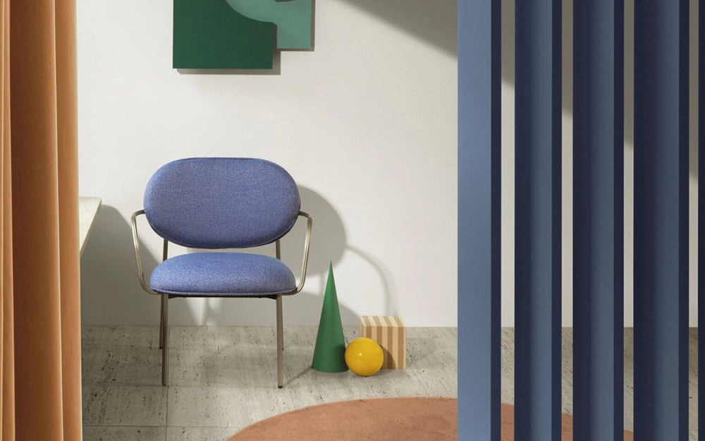 Blume Upholstered Fabric Armchair in Blue Finish Studio Setting