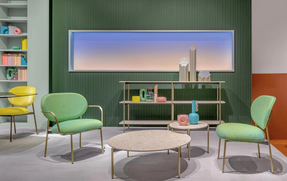 Blume Upholstered Fabric Armchair in Green Finish with Coffee Table and Bookshelves in Breakout Setting