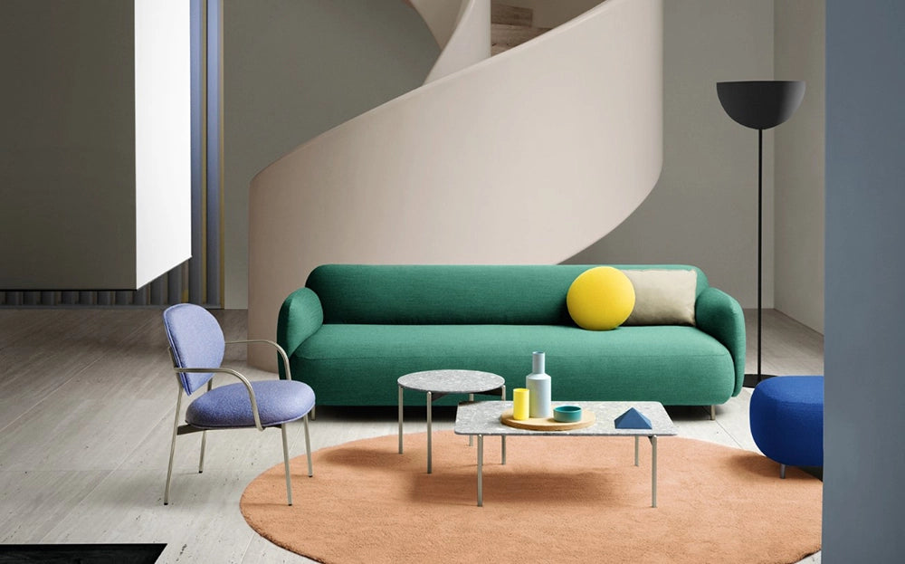 Blume Upholstered Fabric Armchair in Purple Finish with Upholstered Sofa and Coffee Table in Studio Setting