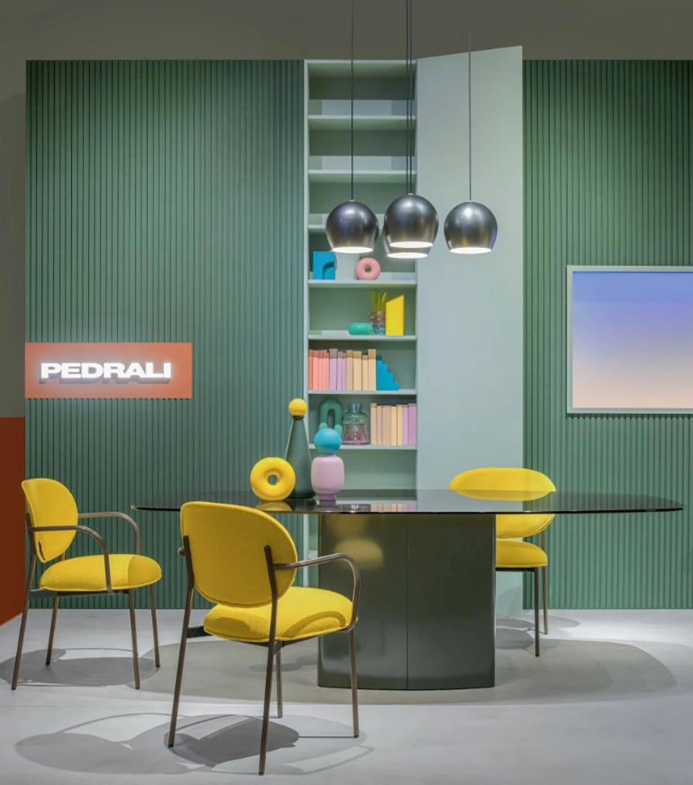 Blume Upholstered Fabric Armchair in Yellow Finish with Rectangular Table and Bookshelves in Office Setting