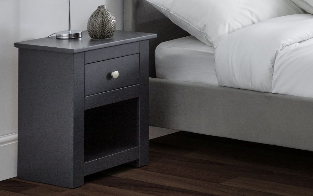 Bradley Bedside Table in Anthracite Finish with Pillows and Vase in Bedroom Setting