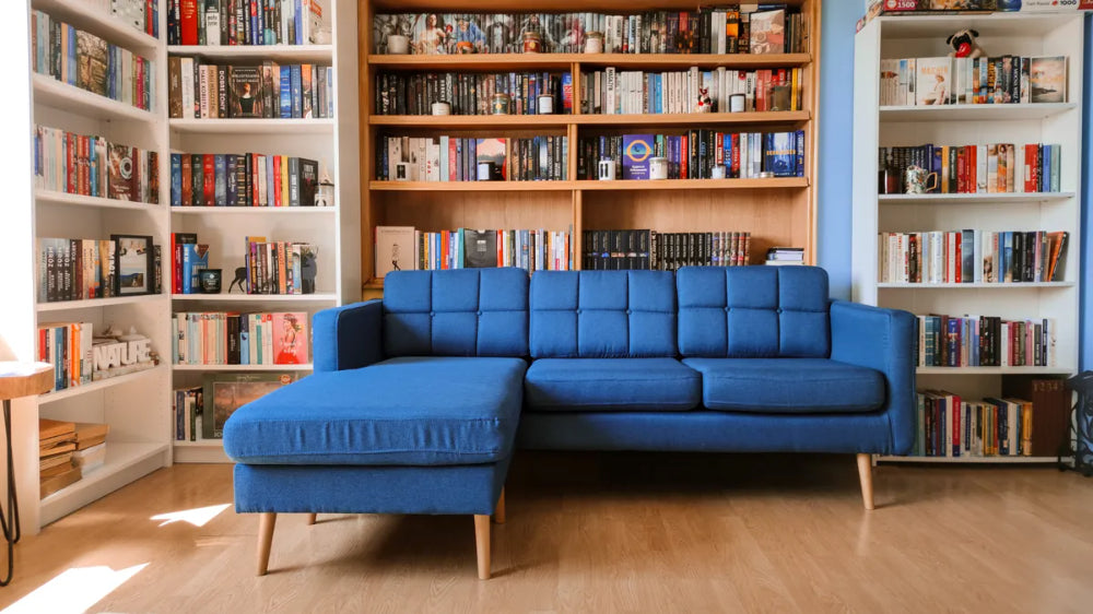 Brent Chaise Sofa in Blue Finish with Bookshelves in Living Room Setting