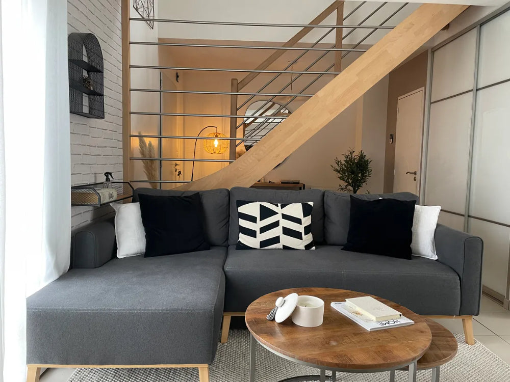 Chase Corner Sofa in Dark Grey Finish with Nesting Table and Indoor Plant in Living Room Setting