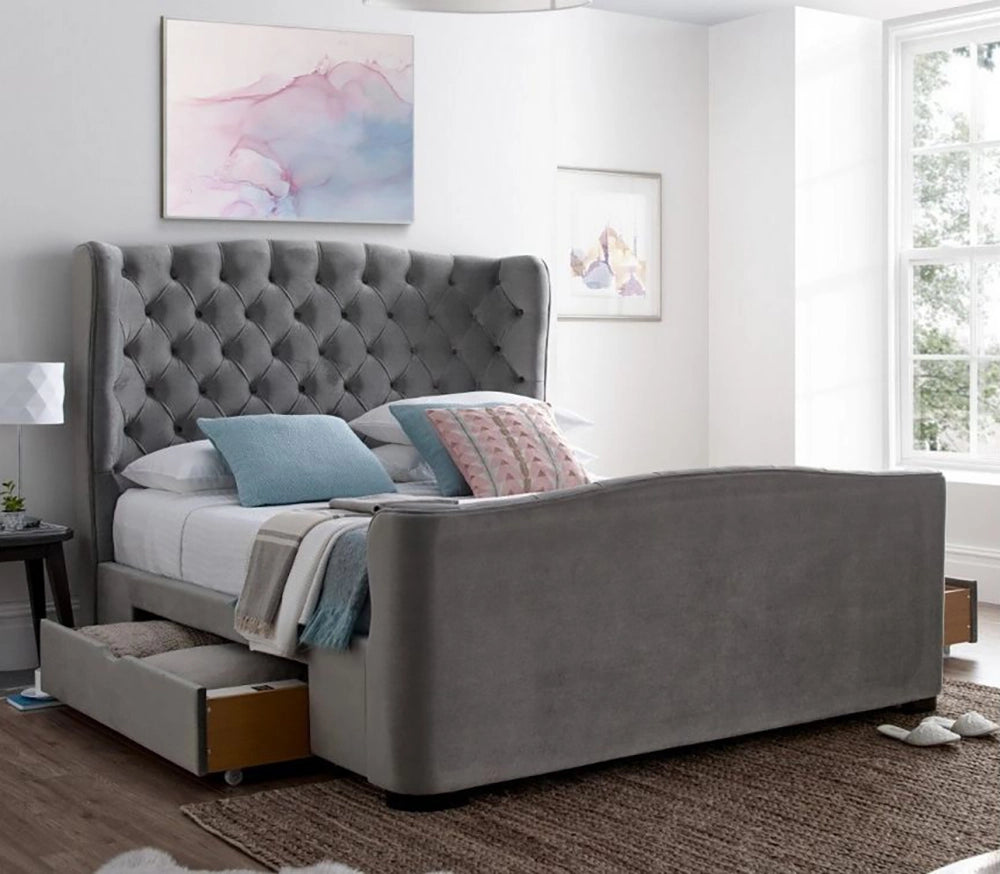 Cora Velvet 2 Drawer Storage Bed in Slate Finish with White Table Lamp and Wall Frame in Bedroom Setting