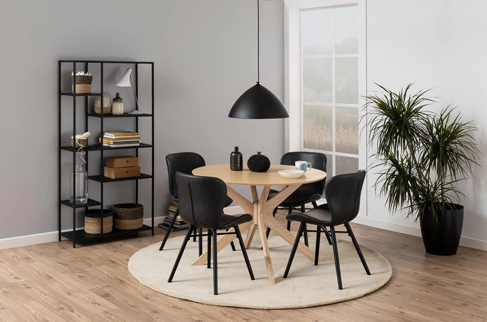 Danica Round Dining Table in White Oak Finish with Black Leather Chair and Indoor Plant in Breakout Setting