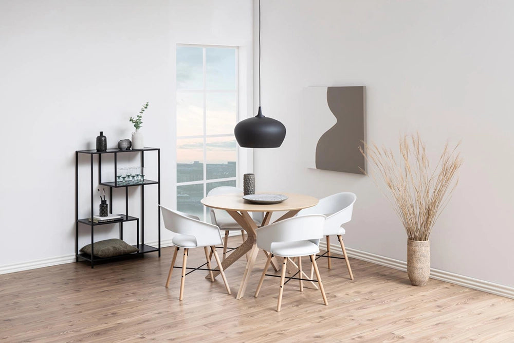 Danica Round Dining Table in White Oak Finish with Tub Chair and Black Metal Shelves in Breakout Setting
