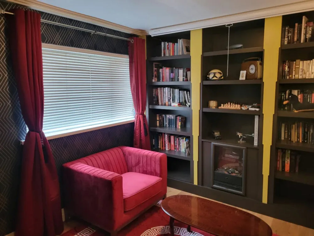 Edwin Armchair in Dark Red Finish with Coffee Table and Bookshelves in Library Setting