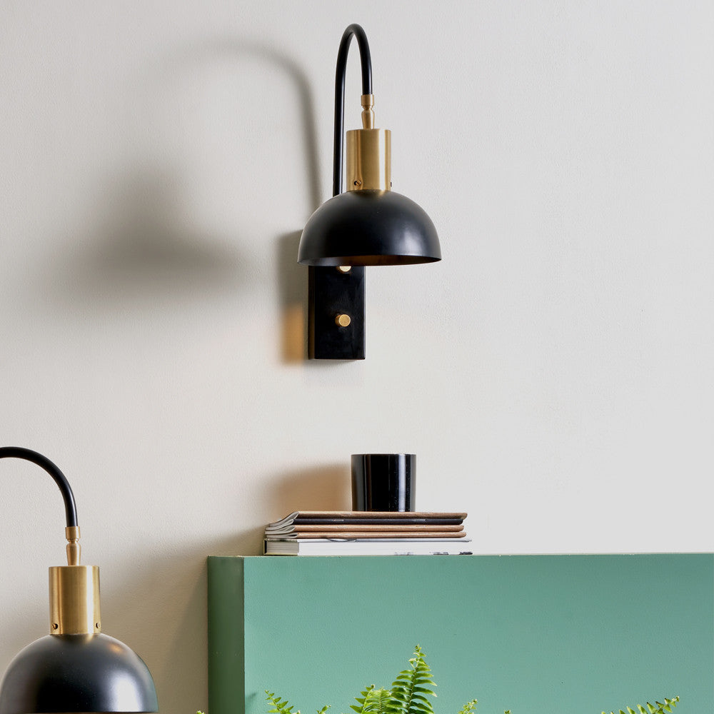 Erago Matt Black Task Wall Light with Indoor Plant in Living Room Setting