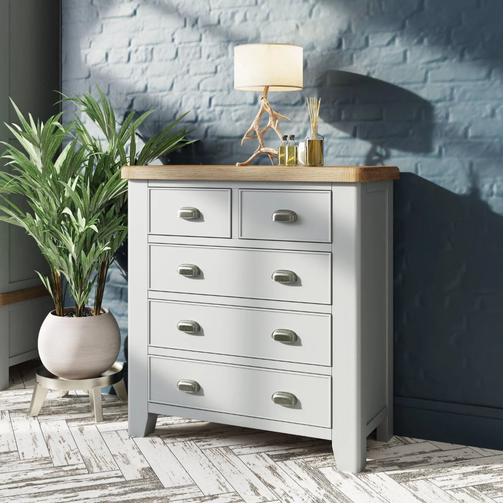 Hadley 2 3 Drawer Chest in Grey Finish with Lampshade and Indoor Plant in Bedroom Setting