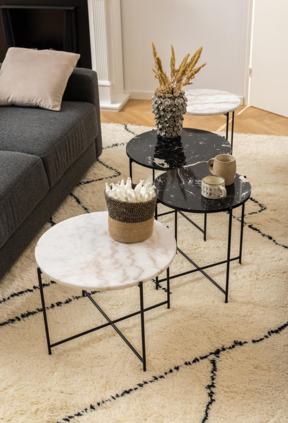 Harlie Marble Top Side Table in Black Finish with Sofa and Floor Rug in Living Room Setting