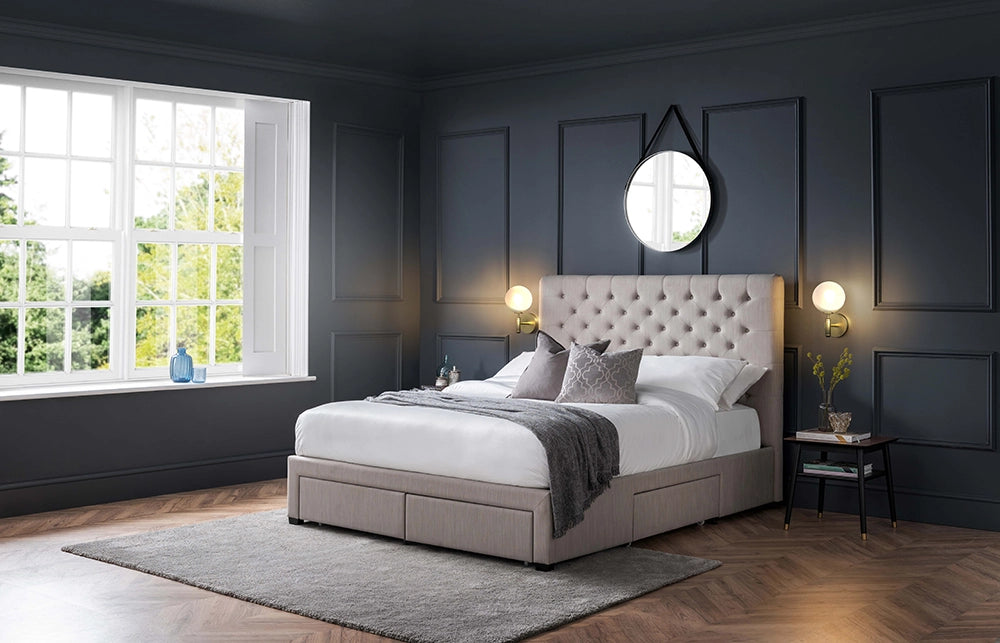 Hilton Deep Button 4 Drawer Bed in Grey Finish Linen with Wall Lamp and Lamp Table in Bedroom Setting
