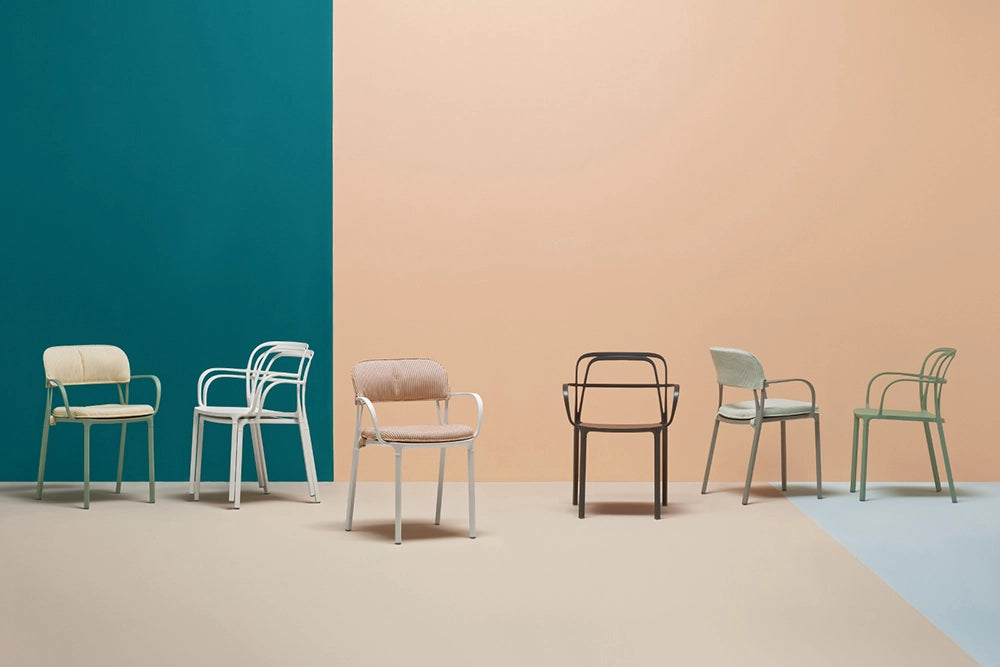Intrigo Dining Chair with Armrests Family in Studio Setting