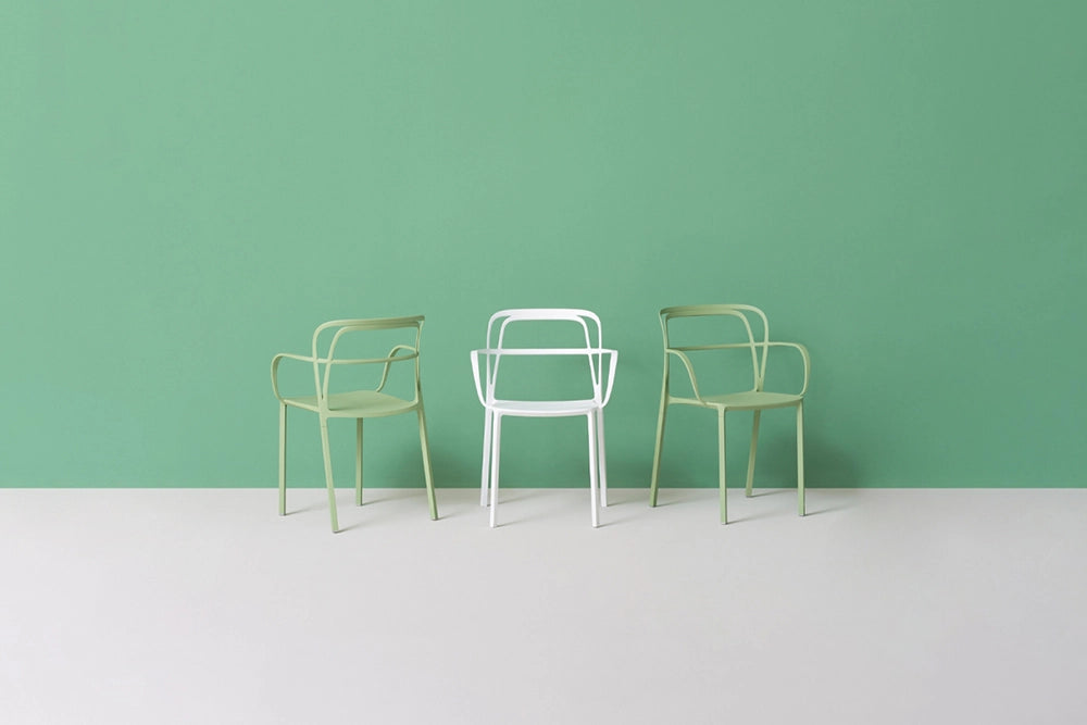 Intrigo Dining Chair with Armrests in Studio Setting