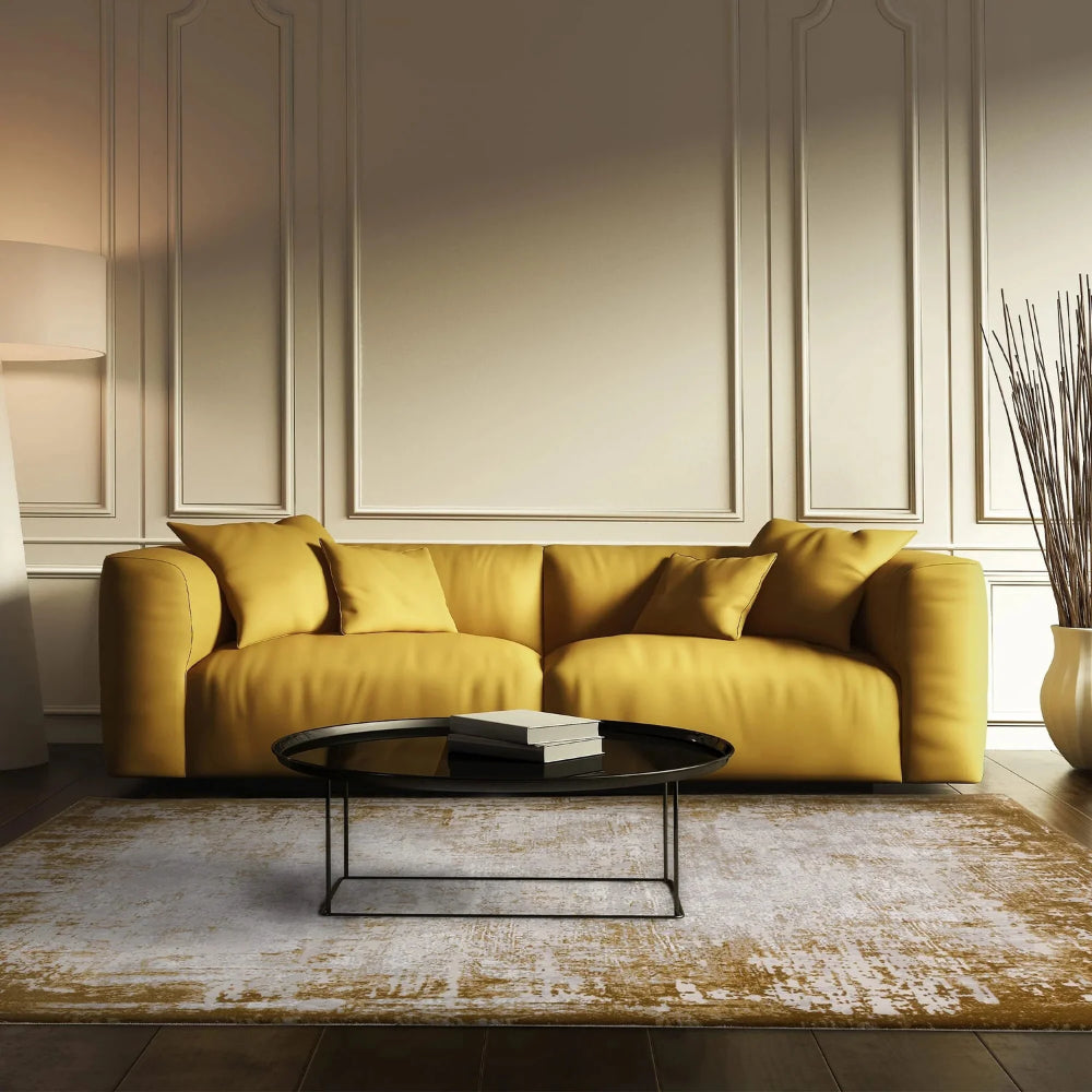 Kazzie Border Rug in Gold Finish with Round Coffee Table and Sofa in Living Room Setting