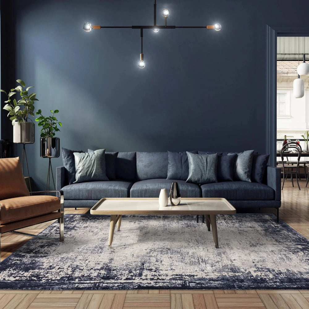 Kazzie Border Rug in Navy Finish with Coffee Table and Sofa in Living Room Setting
