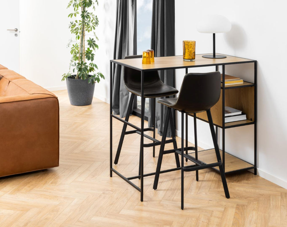 Leo Barstool with Footrest in Black Finish with Indoor Plant and Sofa in Living Room Setting