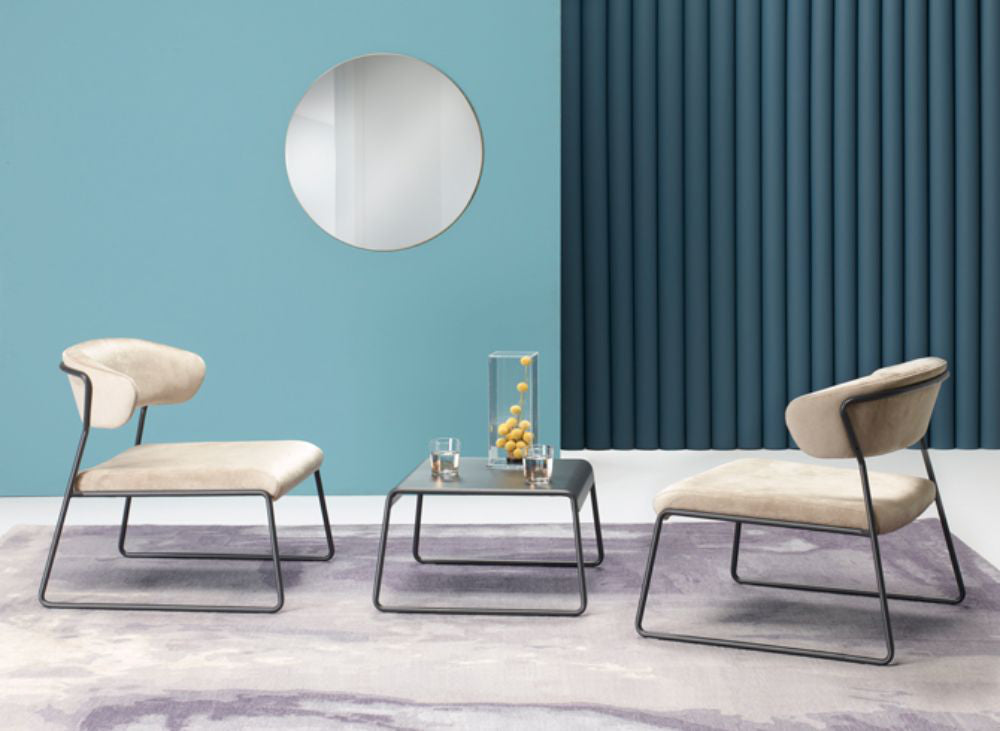 Lisa Lounge Armchair with Coffee Table and Round Mirror in Studio Setting