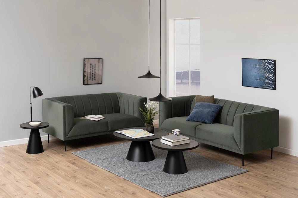 Lola Round Coffee Table in Black Finish with Upholstered Sofa and Black Finish Lamp in Living Room Setting