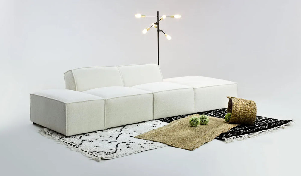Max Corner Sofa in Cream Finish with Floor Rug and Lamp in Studio Setting