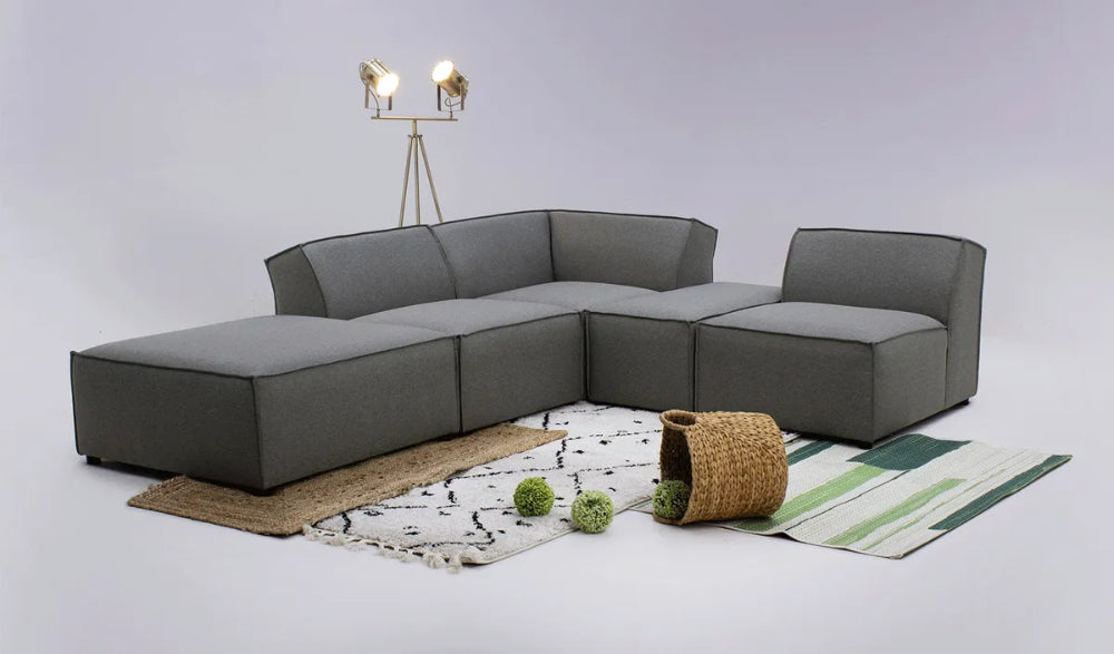 Max Corner Sofa in Dark Grey Finish with Floor Lamp and Rug in Studio Setting