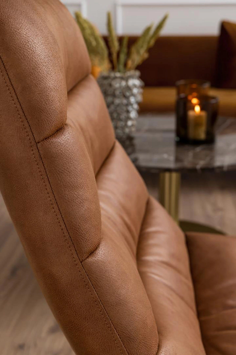 Mindy Lounge Chair in Brandy Finish with Coffee Table and Glass Candle Side Detail in Living Room Setting
