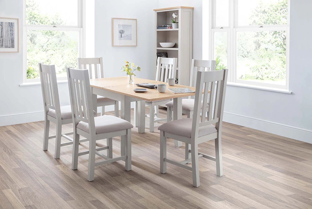 Monde Extending Dining Table in Oak Finish with Wooden Chairs and Shelves in Breakout Setting 2