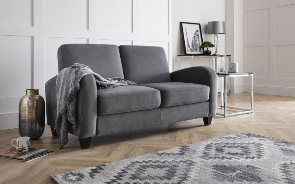 Monza Sofa Bed in Dusk Grey Chenille with Lamp Shade and Floor Rug in Living Room Setting