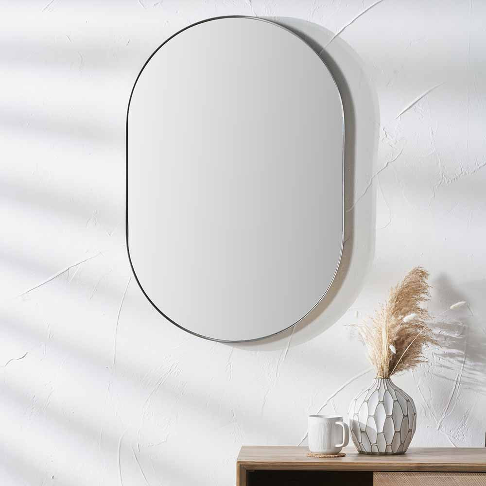 Naples Brushed Silver Metal Slim Frame Oval Wall Mirror Attached in the Wall in Living Room Setting