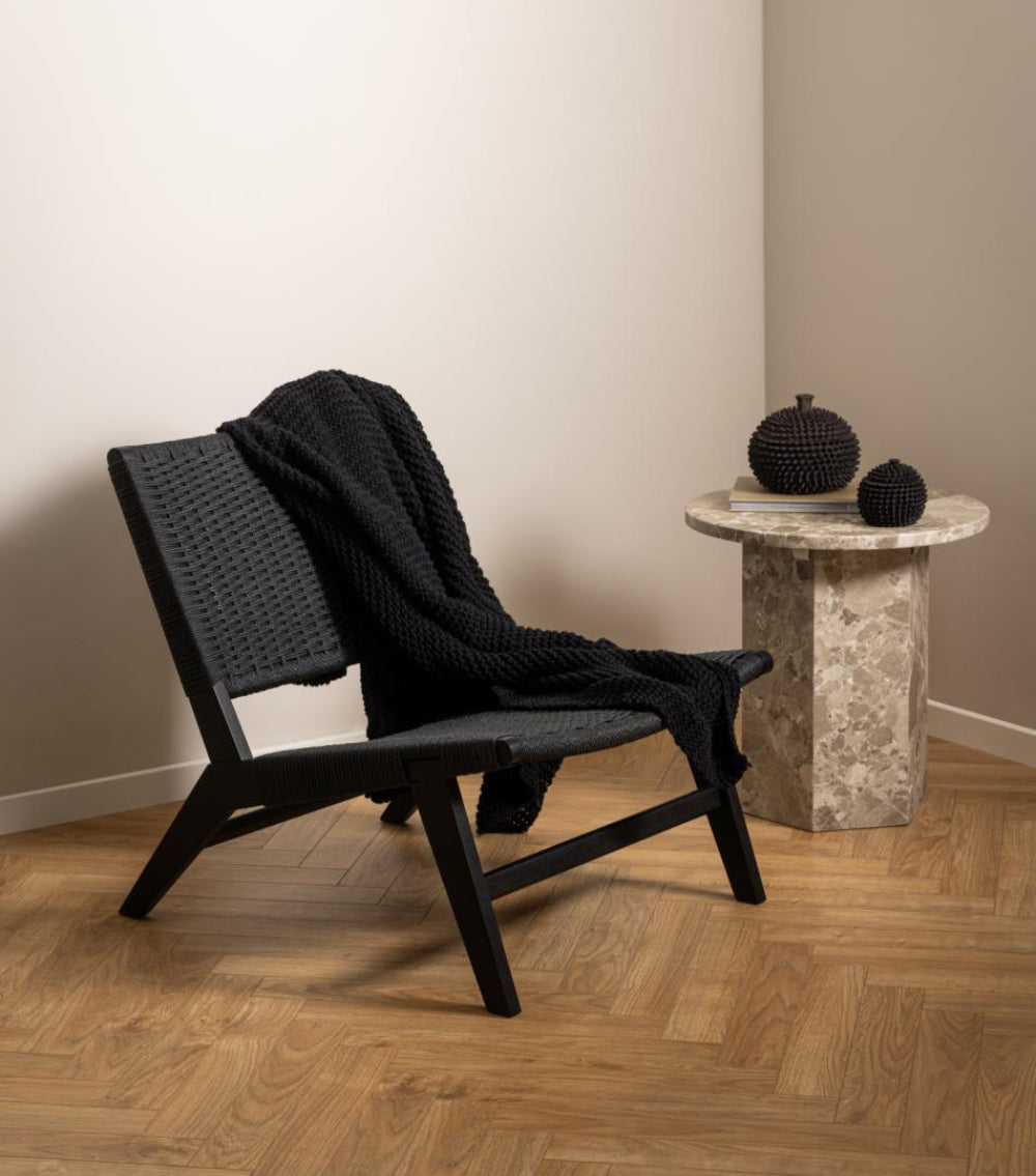 Naria Round Side Table in Latte Finish with Lounge Chair in Living Room Setting