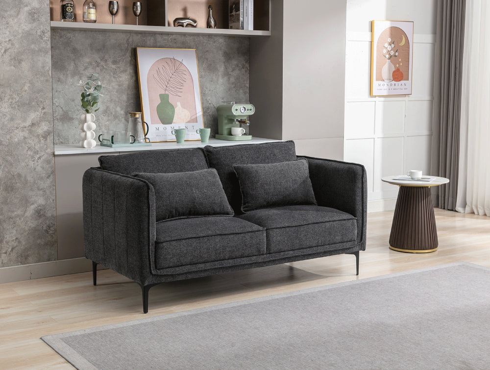 Norris 2 Seater Sofa in Dark Grey Finish with Side Table and Floor Rug in Living Room Setting