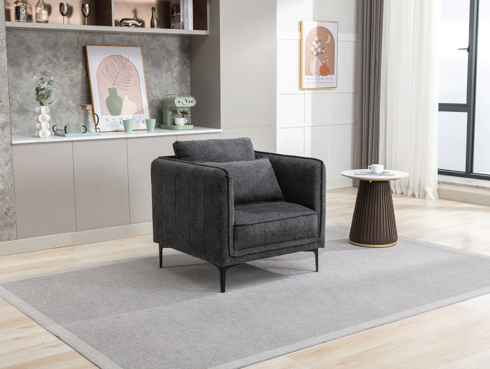 Norris Armchair in Dark Grey Finish with Side Table and Floor Rug in Living Room Setting