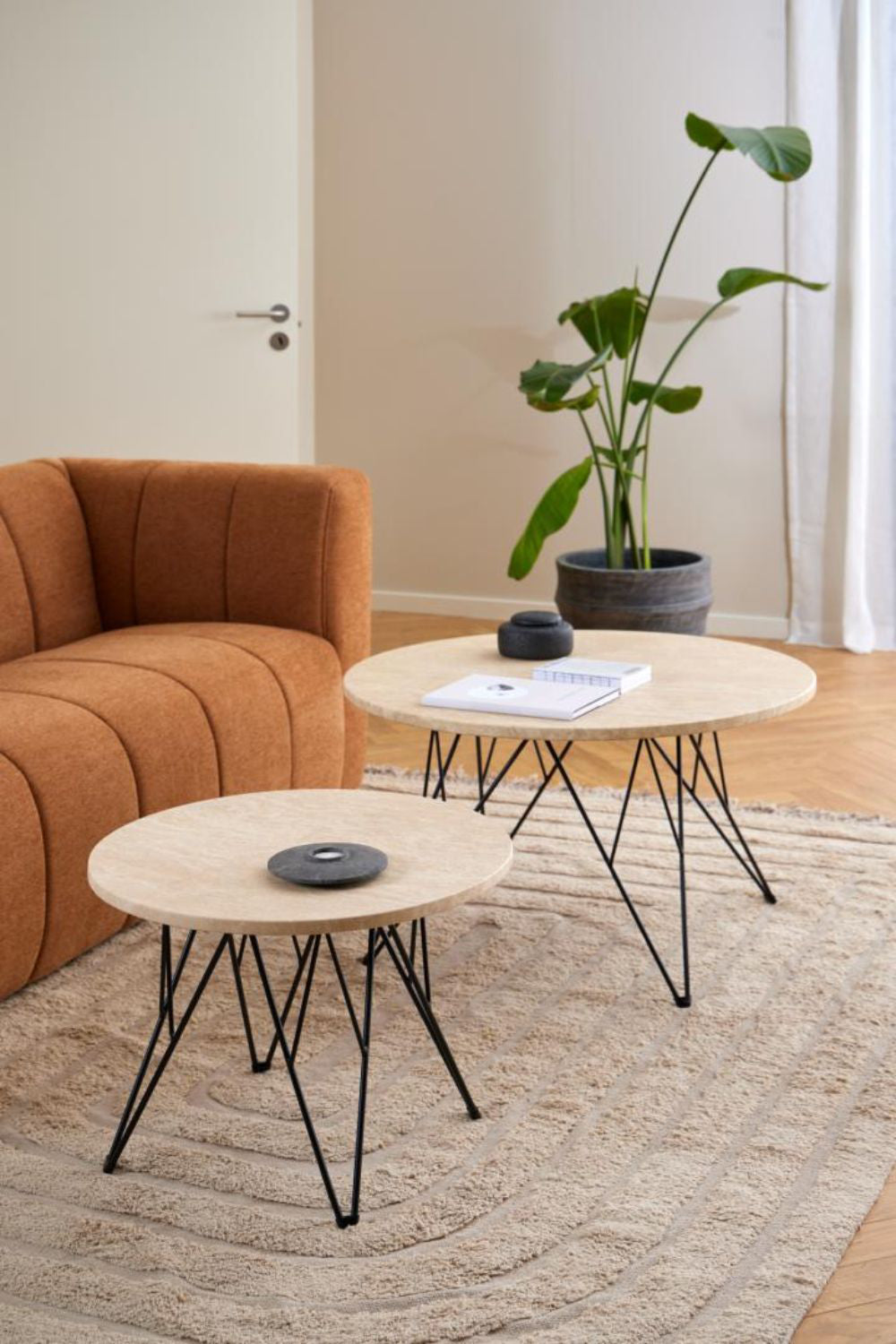Penny Side Table in Beige and Black Finish with Floor Rug and Indoor Plant in Living Room Setting