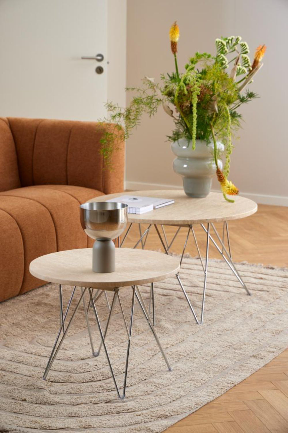 Penny Side Table in Beige and Chrome Finish with Floor Rug and Vase in Living Room Setting