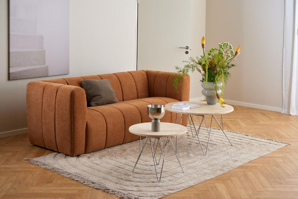 Penny Side Table in Beige and Chrome Finish with Sofa and Indoor Plant in Living Room Setting