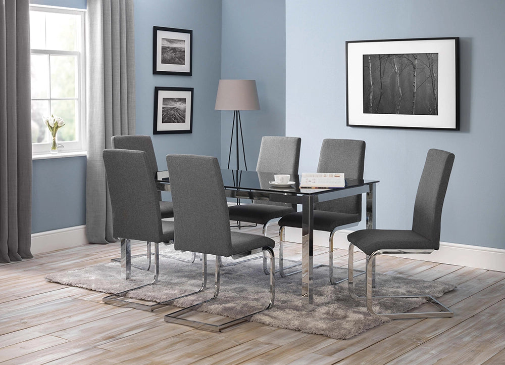 Poppy Glass Dining Table with Grey Upholstered Chairs and Wall Frame in Dining Setting
