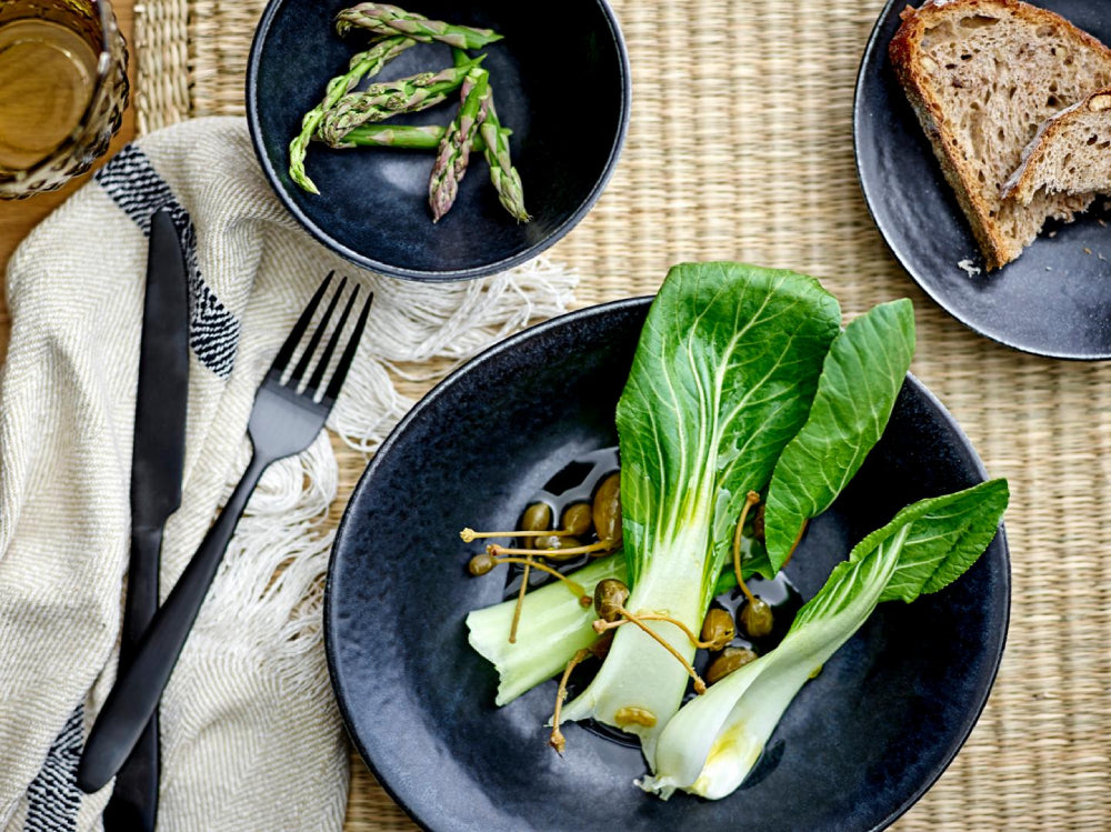 Rea Black Stainless Steel Cutlery Set with Carajay and Fringed Towel in Dining Setting