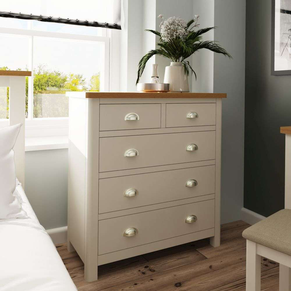 Remy 3 2 Drawer Chest in Truffle Finish with Flower Vase and Chair in Bedroom Setting