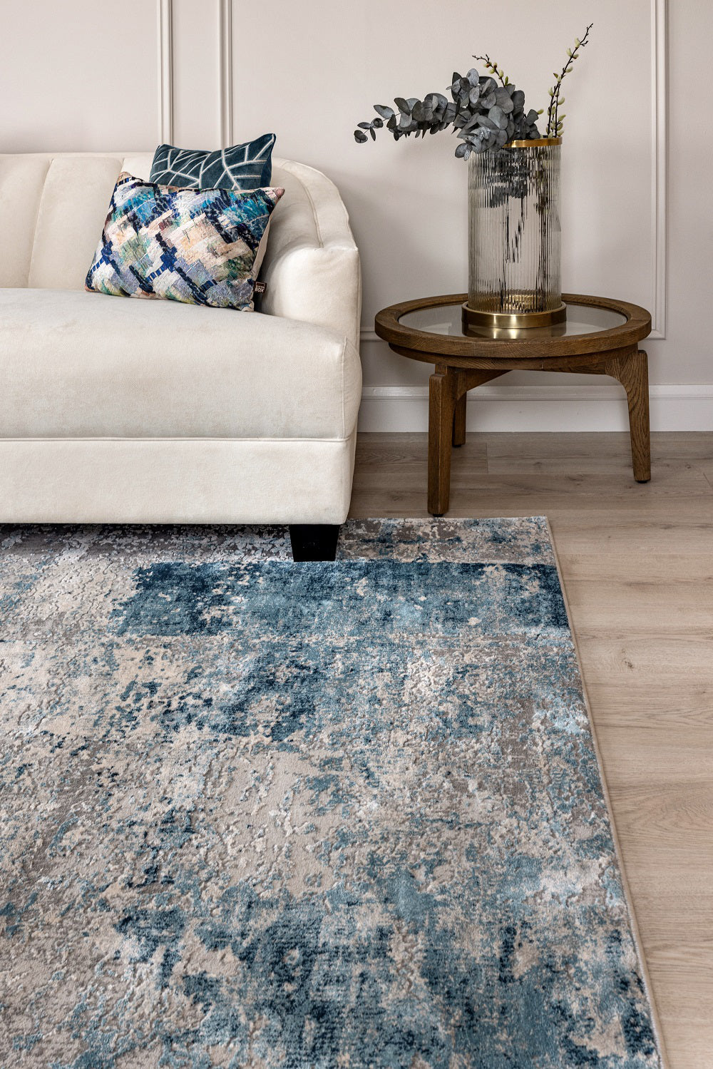Riley Soft Rug in Blue Finish with Coffee Table and Pillows in Living Room Setting