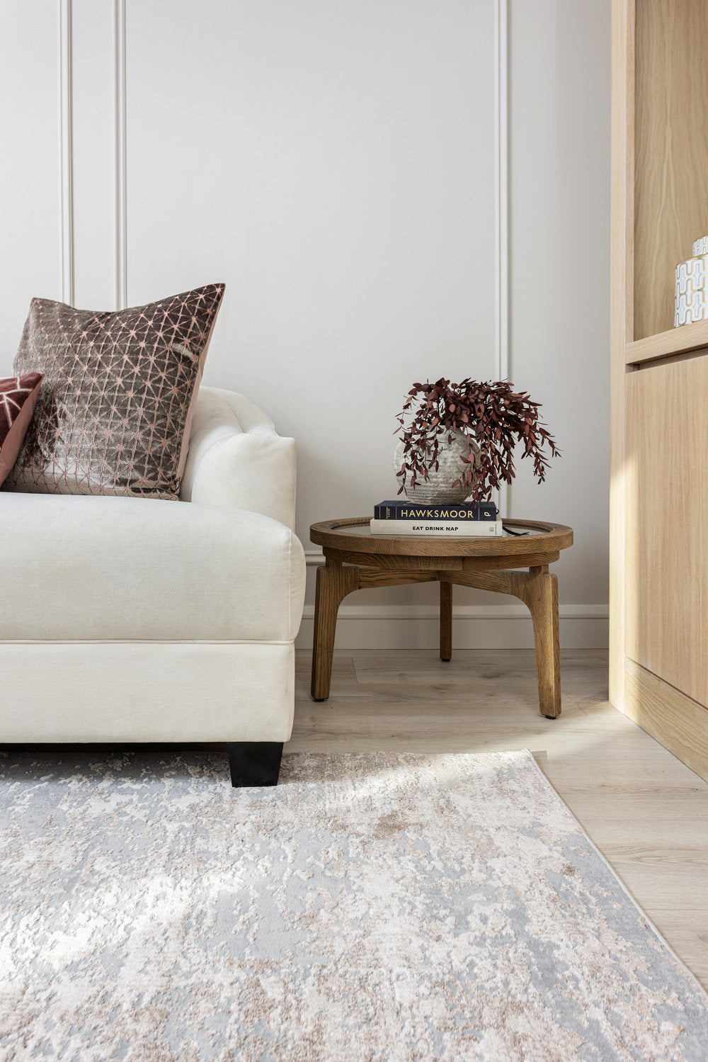 Riley Soft Rug in Mink Finiah with Coffee Table and Pillows in Living Room Setting