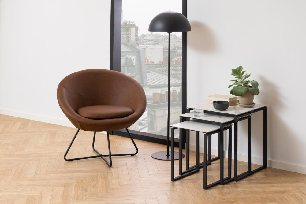 Riva Nest of 3 Tables in White Marble Finish with Brown Lounge Chair and Floor Lamp in Living Room Setting