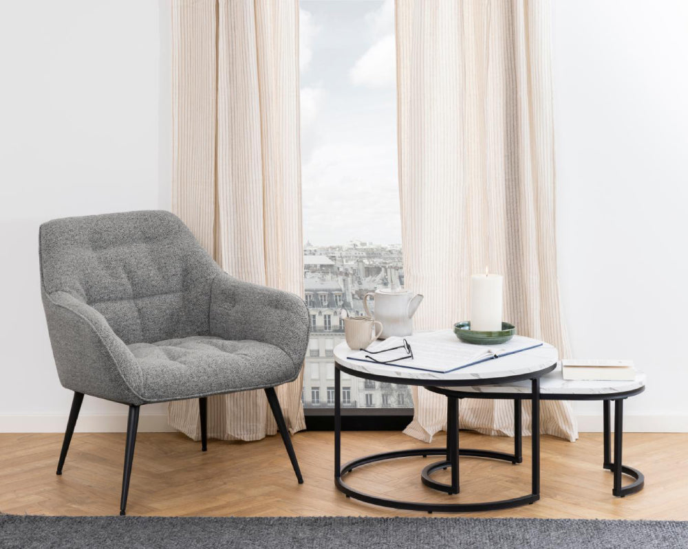 Riva Oval Round Coffee Table in White Marble Finish with Lounge Chair in Living Room Setting