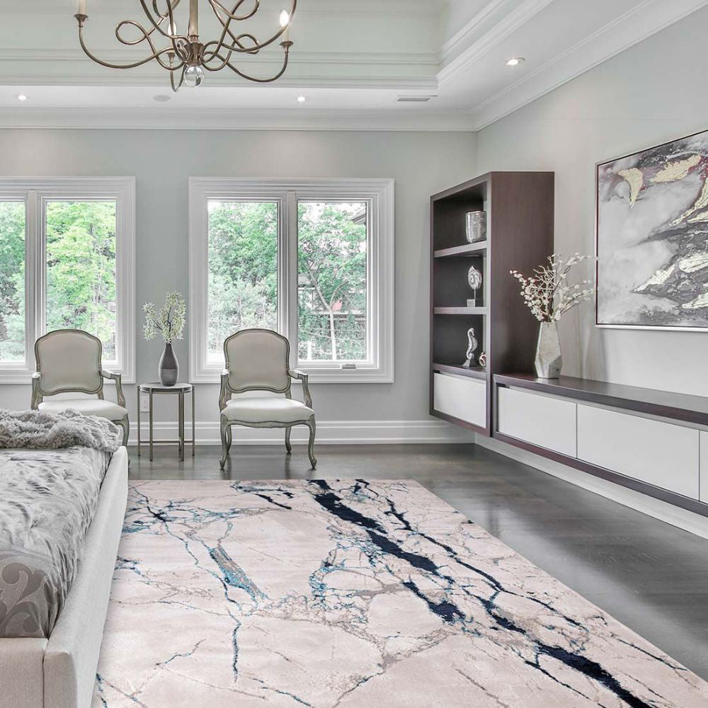 Romey Metallic Floor Rug with Side Table and Lounge Armchair in Bedroom Setting