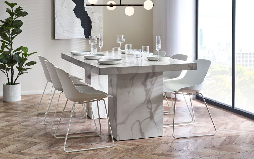 Ryker Marble Dining Table in White Finish with Chair and Indoor Plant in Dining Setting