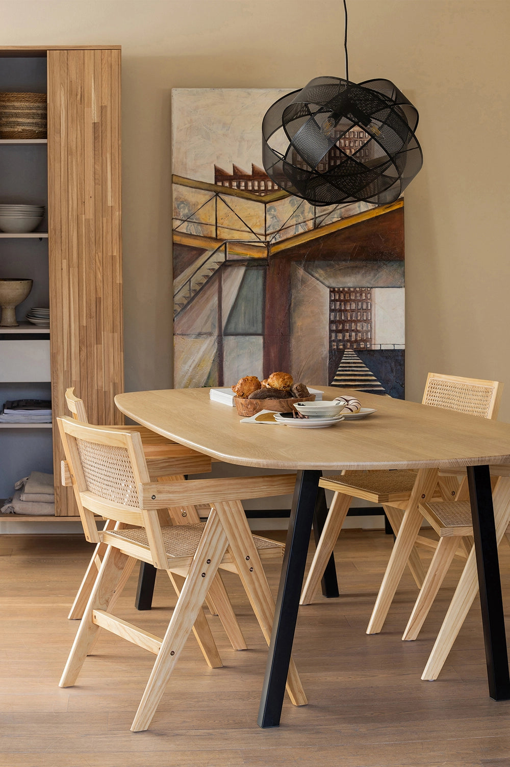 Sierra Dining Chair Natural with Oval Table and Black Hanging Lighting Fixture in Dining Area Setting