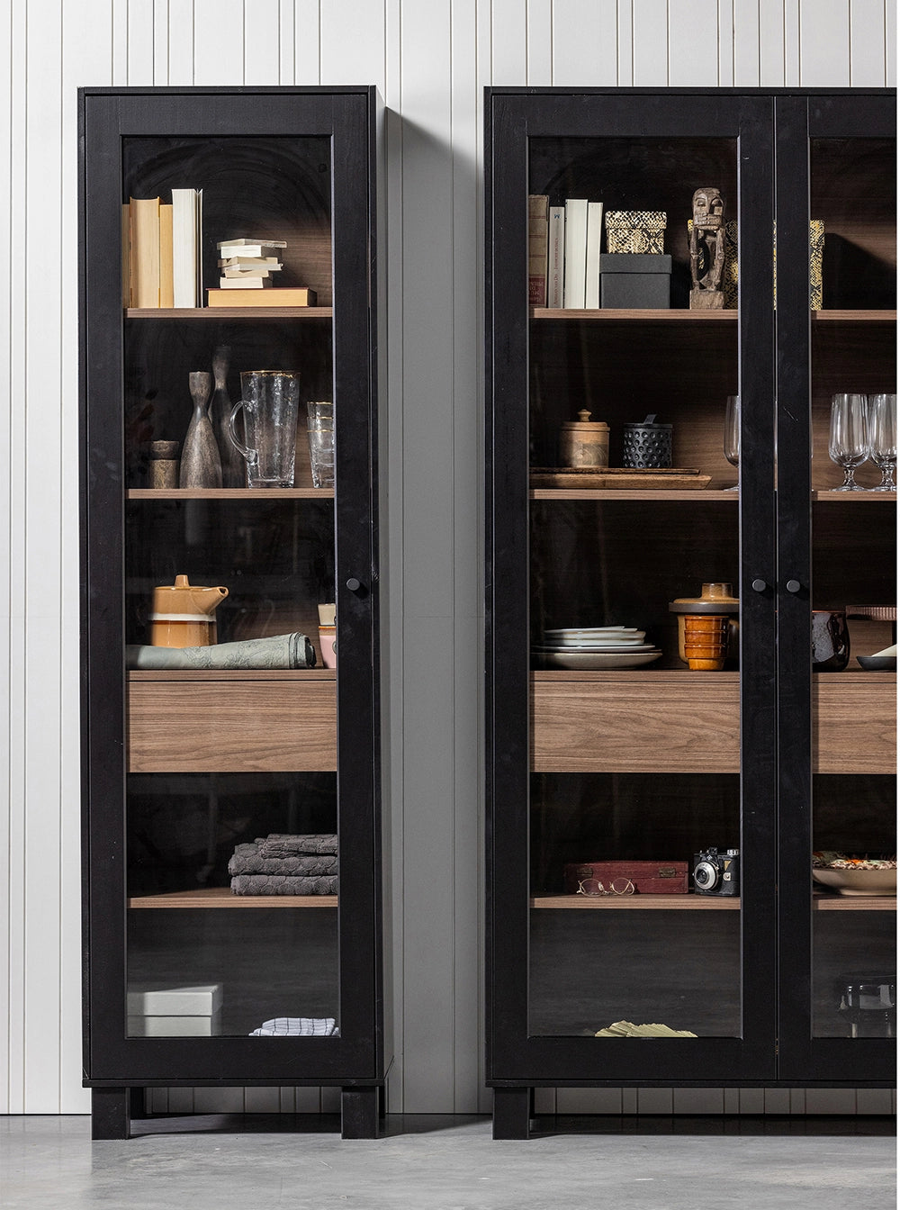Solo Display Cabinet in - Black Walnut Finish with Utensils and Books in Living Room Setting