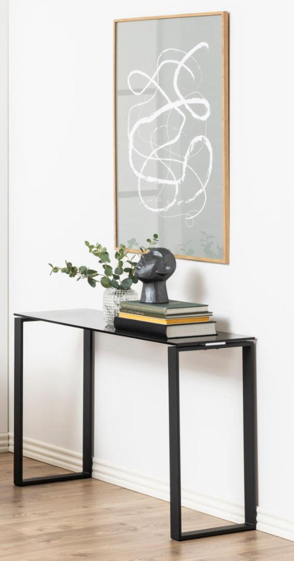 Trina Hall Table Smoked Tempered Glass with Wall Art and Sculpture in Living Room Setting