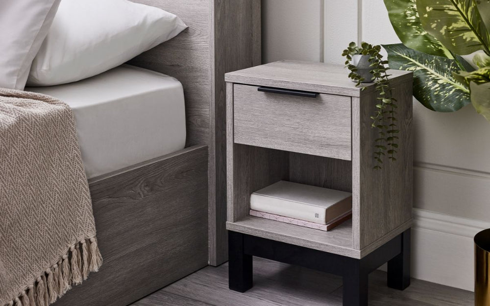 Verona 1 Drawer Bedside Table in Grey Oak Finish with Indoor Plant and Books in Bedroom Setting